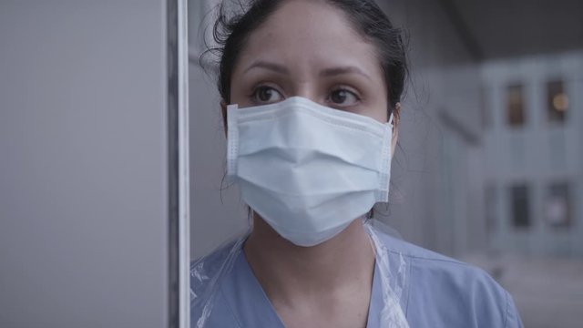 Closeup of nurse holding up door to infection room during coronavirus pandemic