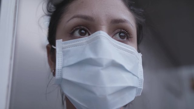 Closeup of nurse with mask outside infection room