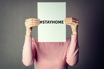 anonymous woman covering face with white paper sheet