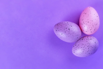 Easter multi-colored eggs on a lilac background