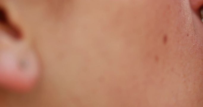 Girlfriend biting partner lip while kissing. Macro extreme closeup of frenc kiss