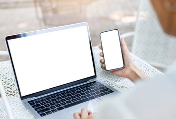 mockup image blank screen computer,cell phone with white background for advertising text,hand woman using laptop texting mobile contact business search information on desk in cafe.marketing,design