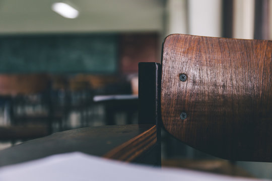 Selective Soft And Blur Focus.old Wooden Row Lecture Chairs In Dirty Classroom In Poor School.study Room Without Student.concept For Education In Third World ,donate And Charity,background Text.