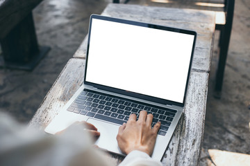 mockup image blank screen computer with white background for advertising text,hand woman using laptop contact business search information on desk at coffee shop.marketing and creative design