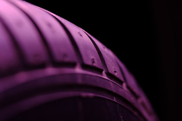 Abstract macro photography – close up tire texture pattern with violet light