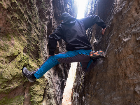 Man climbing from ground to light above head