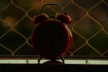 red clock on black background