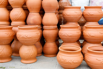 Fototapeta na wymiar many stacked ceramic pots of different shapes and sizes