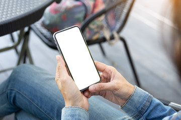 Mockup image blank white screen cell phone.woman hand holding texting using mobile on desk at coffee shop.background empty space for advertise text.people contact marketing business,technology
