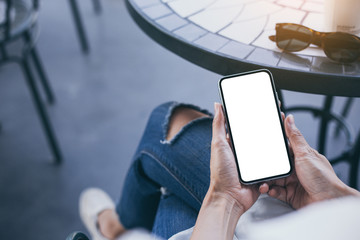 Mockup image blank white screen cell phone.woman hand holding texting using mobile on desk at coffee shop.background empty space for advertise text.people contact marketing business,technology