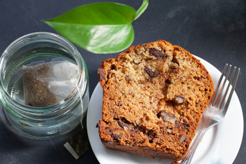 Homemade banana walnut pastry served with a glass of green tea.