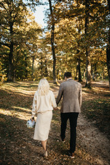 Fototapeta premium The bride in a beautiful dress and the groom in a suit on their wedding day