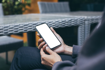 Mockup image blank white screen cell phone.woman hand holding texting using mobile on desk at coffee shop.background empty space for advertise text.people contact marketing business,technology