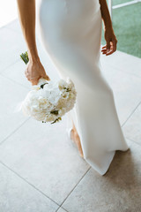 The bride in a beautiful wedding dress with a bouquet in her hand