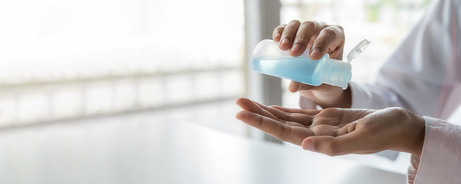 Asian woman washing hand with alcohol sanitizer gel to avoid contaminating with Coronavirus. Medical and Health concept.