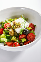 Greek salad in white bowl