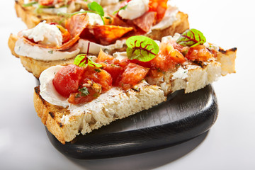 Bruschetta with baked tomatoes closeup view