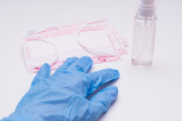 Protective mask, disinfectants and gloves. Hygiene concept. prevent the spread of germs and...