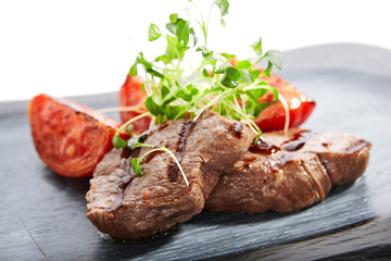 Grilled marbled beef with tomatoes top view