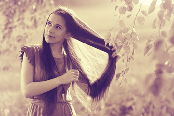 Brunette with long strong beautiful hair summer photo