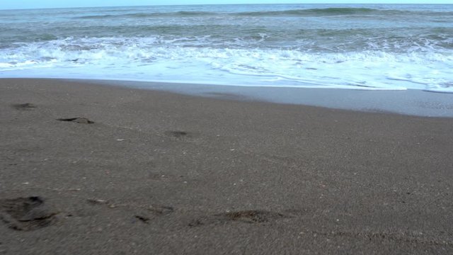 Walking towards the sea. Dolly in, walkers POV