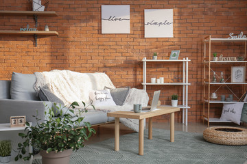 Interior of living room with comfortable sofa and table