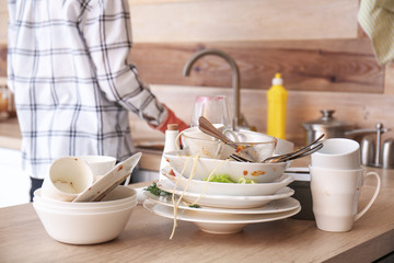 Many dirty dishes on kitchen table