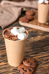 Cup of hot chocolate with cookies on table