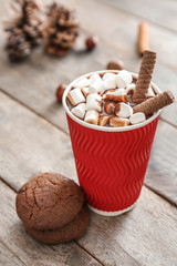 Cup of hot chocolate with cookies on table