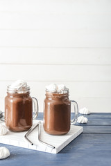 Mason jars of hot chocolate on table