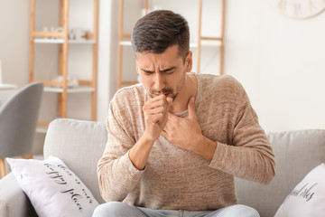 Coughing young man at home
