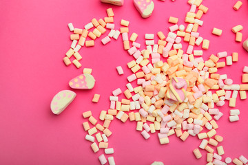 Sweet marshmallows on color background