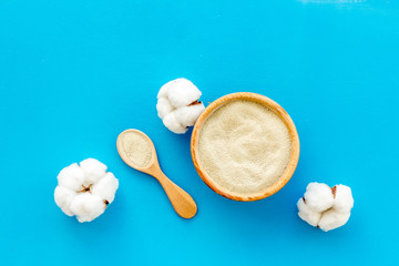 White cosmetic clay on blue background top-down