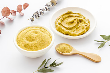 Yellow cosmetic clay - skin cleansing concept - on white background