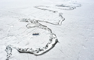 Abstract aerial view of a hovercraft on a frozen lake ice. Lake Baikal, Siberia, Russia.