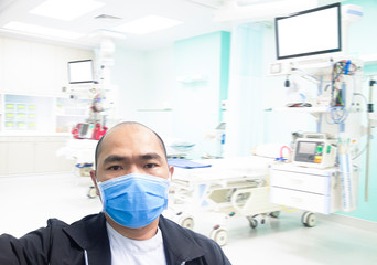 Fototapeta na wymiar Asian male nurses wear nose pads To prevent the flu and Covid-19 While performing duties in emergency room the hospital