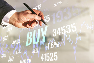 Man hand with pen working with abstract virtual financial graph on blurred office background, forex...