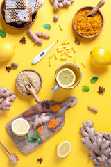 Fototapeta na wymiar Medical care concept. Cold, flu treatment. Ginger, lemon, honey, pills, drugs, supplements, thermometer on yellow background. Natural alternative holistic approach. Top view, copy space
