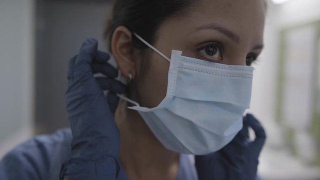 Closeup of nurse applying mask in slow motion during the corona virus pandemic.