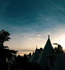Silhouette of indian tribe wigwam in the morning sunrise © septian