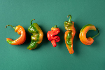 Ugly bell pepper on green background. Concept of zero waste production. Top view. Copy space. Non...