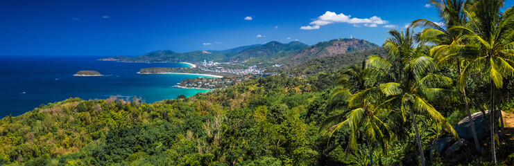 Fototapeta na wymiar Panorama of the tropical island of Phuket with green trees on the foreground and perfect sandy beaches on the horizon, Thailand