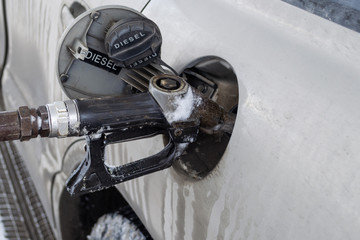 Refueling a car’s fuel tank with diesel