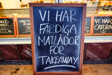 Fototapeta premium Stockholm, Sweden A fish store in Hogdalen advertises for takeaway on a blackboard. 
