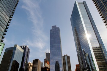 Obraz premium Modern skyscrapers in a financial district at sunset, looking up perspective, real estate and success concept, USA