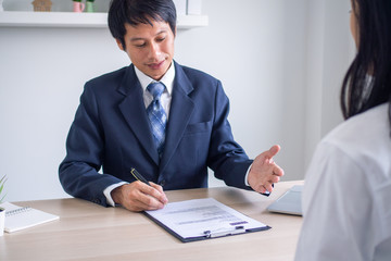 The employer is reading the resume during a conversation about the job applicant's resume. The employer in the suit is conducting a job interview, hiring manager resources and recruitment ideas. 