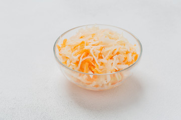 Homemade fermented cabbage with carrot in glass bowl. Pickled cabbage with carrots.  