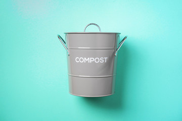 Recycling food waste bin for compost on blue background. Top view. Copy space. Sustainable and zero waste living.
