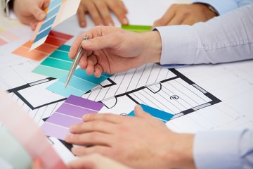 interior design, architecture and people concept - close up of designers team working with...