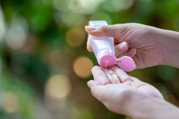 Hand sanitizer bottle gel protect from virus. Female Pouring alcohol gel cleaning virus on sanitizing hands, close up.